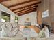 Cozy living room with a brick fireplace, exposed wood beams, hardwood floors, and comfortable seating at 1075 Dudley St, Lakewood, CO 80215