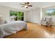 Serene main bedroom with large windows, hardwood floors, and ample closet space at 1075 Dudley St, Lakewood, CO 80215