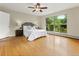 Comfortable main bedroom with large picture window, wood floors, and neutral paint at 1075 Dudley St, Lakewood, CO 80215