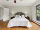 Inviting main bedroom with hardwood floors, a large window, and stylish decor at 1075 Dudley St, Lakewood, CO 80215