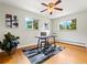 Bright office space featuring hardwood floors, modern ceiling fan, and large windows with natural light and views at 1075 Dudley St, Lakewood, CO 80215