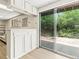 The basement bar area features sliding doors which open to a patio and beautiful outdoor views at 1075 Dudley St, Lakewood, CO 80215