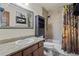 Bathroom with granite vanity and shower with neutral stone-look tile at 15149 E Princeton Pl # B, Aurora, CO 80014