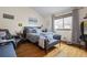 Serene bedroom with hardwood floors, a large window, and ample natural light at 15149 E Princeton Pl # B, Aurora, CO 80014