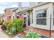 Close up of front entrance of brick townhome with lush flower garden at 15149 E Princeton Pl # B, Aurora, CO 80014