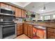 Modern kitchen featuring stainless steel appliances, granite countertops, and custom cabinetry at 15149 E Princeton Pl # B, Aurora, CO 80014