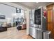 Inviting living room with a fireplace, hardwood floors, and stainless steel refrigerator at 15149 E Princeton Pl # B, Aurora, CO 80014