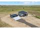 A newly constructed home with a detached garage sits on a large, open lot at 995 Pinehurst Ct, Bennett, CO 80102