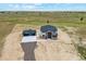 Aerial view of a large home with a detached garage on a large lot at 995 Pinehurst Ct, Bennett, CO 80102