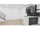 Basement bar featuring an island and stairs at 995 Pinehurst Ct, Bennett, CO 80102