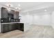 A well-appointed basement bar features custom cabinets and a wine fridge at 995 Pinehurst Ct, Bennett, CO 80102