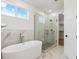 Modern bathroom features a freestanding tub and a separate glass-enclosed shower at 995 Pinehurst Ct, Bennett, CO 80102