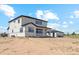 A two-story stucco home with a covered porch and a detached garage at 995 Pinehurst Ct, Bennett, CO 80102