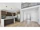 Modern kitchen with dark cabinets, stainless steel appliances, and a center island at 995 Pinehurst Ct, Bennett, CO 80102