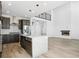 Contemporary kitchen with an island, stainless steel appliances, and dark wood cabinetry at 995 Pinehurst Ct, Bennett, CO 80102