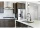 Modern kitchen featuring stainless steel appliances, gas range, and a large island with a sink at 995 Pinehurst Ct, Bennett, CO 80102
