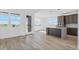 Bright, open kitchen with modern appliances, an island, and hardwood floors at 995 Pinehurst Ct, Bennett, CO 80102