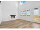 Bright living room with fireplace, large windows, and access to the outdoors at 995 Pinehurst Ct, Bennett, CO 80102