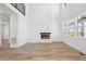 Spacious living room with fireplace, hardwood floors, and a modern staircase at 995 Pinehurst Ct, Bennett, CO 80102