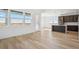 Sun-filled living area with hardwood floors and a view of the spacious backyard at 995 Pinehurst Ct, Bennett, CO 80102