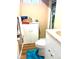 Bathroom featuring a toilet, white cabinets, a turquoise rug, and linoleum flooring at 1516 S Lowell Blvd, Denver, CO 80219
