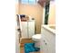 Bathroom featuring a toilet, white cabinets, a turquoise rug, and linoleum flooring at 1516 S Lowell Blvd, Denver, CO 80219