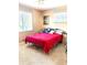 Bedroom featuring window, a queen sized bed, with carpet flooring, and a nightstand at 1516 S Lowell Blvd, Denver, CO 80219