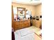 This bedroom features carpet floors, a ceiling fan, and a natural wood finish dresser with a decorative mirror at 1516 S Lowell Blvd, Denver, CO 80219