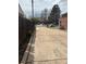 This long driveway is complimented by a wood fence and colorful spring flowers at 1516 S Lowell Blvd, Denver, CO 80219