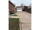 This property features a long driveway leading to a detached two-car garage with a white door at 1516 S Lowell Blvd, Denver, CO 80219