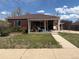 Charming brick home with a cozy front porch and well-maintained lawn, perfect for relaxing outdoors at 1516 S Lowell Blvd, Denver, CO 80219
