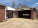 A spacious garage features a white car, good lighting, and additional storage space at 1516 S Lowell Blvd, Denver, CO 80219