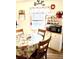 Charming kitchen with a rustic hutch, wooden table with pineapple patterned tablecloth, and plentiful natural light at 1516 S Lowell Blvd, Denver, CO 80219