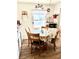 Charming kitchen with a rustic hutch, wooden table with pineapple patterned tablecloth, and plentiful natural light at 1516 S Lowell Blvd, Denver, CO 80219