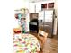 Modern kitchen with stainless steel appliances, white cabinets, an eat-in table, and hardwood floors at 1516 S Lowell Blvd, Denver, CO 80219