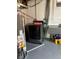 Laundry area with a hot water tank, utility sink, and a modern washer at 1516 S Lowell Blvd, Denver, CO 80219