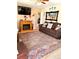 Inviting living room with a fireplace, TV, sofa, and patterned rug, perfect for relaxing or entertaining at 1516 S Lowell Blvd, Denver, CO 80219