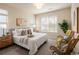 Serene bedroom featuring neutral tones, a comfortable bed, and ample natural light from large windows at 303 Inverness S Way # 101, Englewood, CO 80112