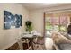Cozy dining area next to living room and balcony offering outdoor views and natural light at 303 Inverness S Way # 101, Englewood, CO 80112