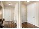 Hallway featuring a smooth ceiling, baseboards, and paneled doors with wood flooring at 303 Inverness S Way # 101, Englewood, CO 80112