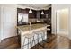 Open kitchen featuring granite counters, dark cabinets, pendant lighting and stainless steel appliances at 303 Inverness S Way # 101, Englewood, CO 80112