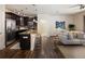 Gourmet kitchen with dark cabinets, granite counters, stainless appliances, and bar stool seating at island at 303 Inverness S Way # 101, Englewood, CO 80112