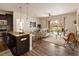 Open concept living and kitchen area with hardwood floors, neutral colors, and patio access at 303 Inverness S Way # 101, Englewood, CO 80112