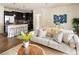 Inviting living room flows into a modern kitchen with a granite counter bar and stainless steel appliances at 303 Inverness S Way # 101, Englewood, CO 80112
