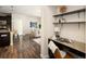 Cozy office nook with desk and shelving, adjacent to the kitchen and living area at 303 Inverness S Way # 101, Englewood, CO 80112