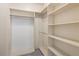 Spacious walk-in closet with built-in shelving and ample storage space at 303 Inverness S Way # 101, Englewood, CO 80112