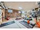 Finished basement gym featuring exposed brick wall, workout equipment, and climbing wall at 680 N Emerson St, Denver, CO 80218