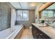 Modern bathroom features double sinks, granite counters, tiled walls, and a separate tub and shower at 680 N Emerson St, Denver, CO 80218