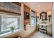 Charming bathroom featuring a decorative sink, stylish mirror, and natural window coverings at 680 N Emerson St, Denver, CO 80218