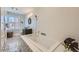 Modern bathroom featuring a soaking tub, unique wall texture and mosaic tile floors at 680 N Emerson St, Denver, CO 80218